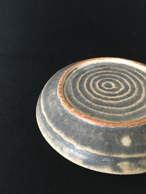 The alluring deep earth plate is a handmade ceramic from Kyoto Japan